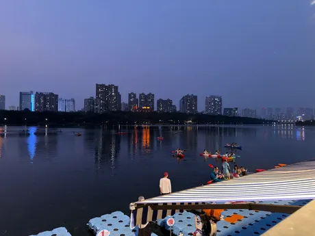 A city skyline at dusk across a still river